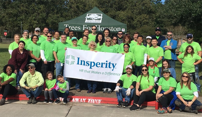 Insperity volunteers holding banner
